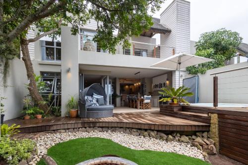 an image of a house with a backyard with a lawn at Kaya Anvi - Plettenberg Bay in Plettenberg Bay