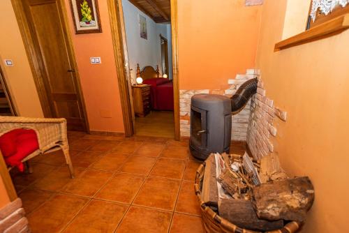 a living room with a brick wall with a heater at Casa la Campa in Cardes