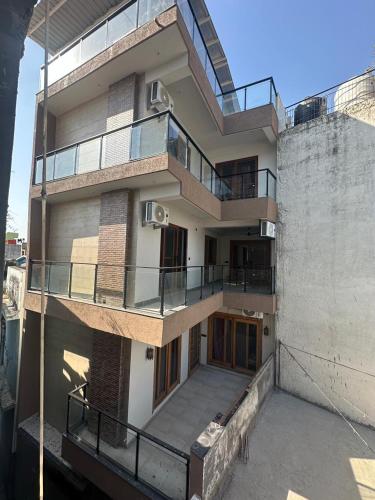 a building with balconies on the side of it at Yes Hotel By The Ganges in Rishīkesh