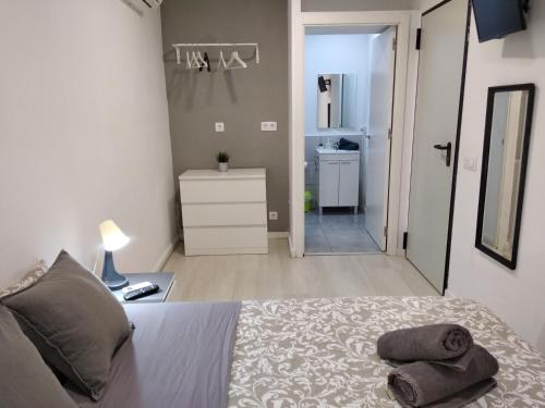 a bedroom with a bed with two pillows on it at Hostal Urban Basic in Hospitalet de Llobregat