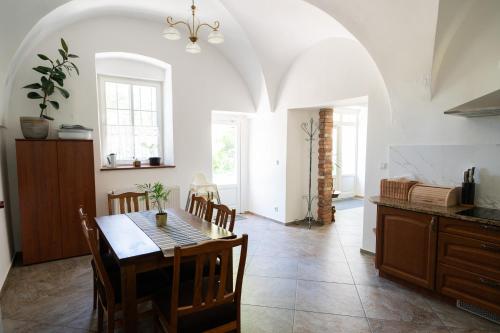 a kitchen and dining room with a table and chairs at Pokoje Gościnne Dom św. Szymona in Kraków
