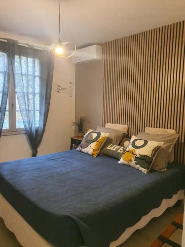 a bedroom with a large bed with pillows on it at Les Feuillantines Perigord Noir in Saint-Cyprien