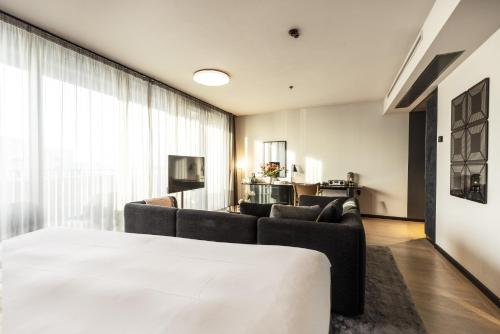 a living room with couches and a large window at At Six in Stockholm