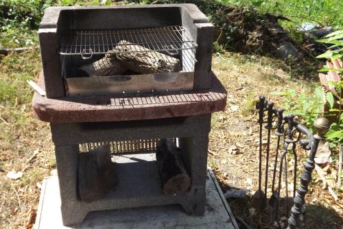 a stone grill with a bunch of tools on it at Appartamento Perla in front of the Castle- Pool, wellness&Special Dinner in Tresana