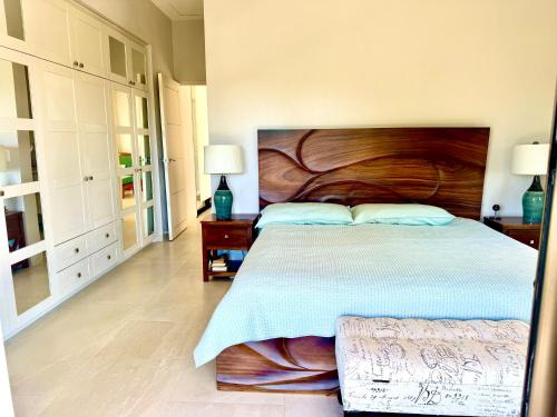 a bedroom with a large bed with a wooden headboard at Villas with breathtaking seaview in Marbella
