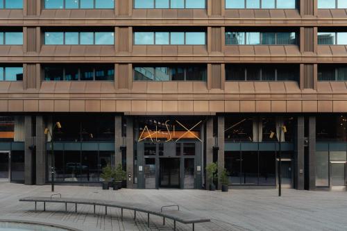a building with two benches in front of it at At Six in Stockholm