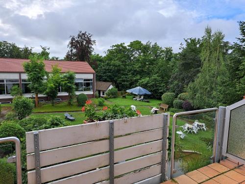a fence in front of a house with a garden at Hotel Heikenberg in Bad Lauterberg