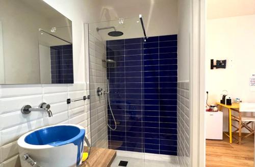 a bathroom with a blue tiled shower with a blue tub at Voglia d'aMare in Numana