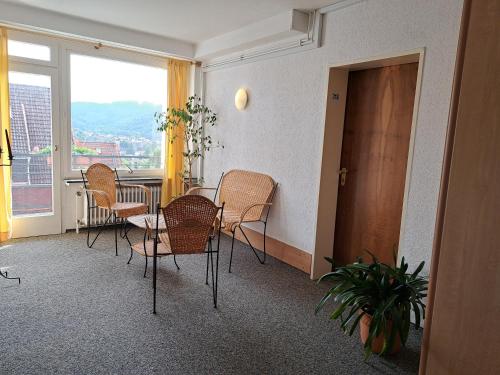 a dining room with a table and chairs and a window at Hotel Heikenberg in Bad Lauterberg