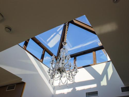 a chandelier hanging from a ceiling in a room at BiBo Suites Real Chancilleria in Granada