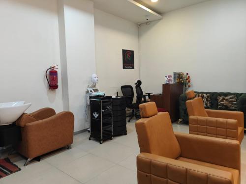 a hair salon with chairs and a sink in a room at Modern 3BHK with fully equipped kitchen on 15Floor only for families in Bengaluru