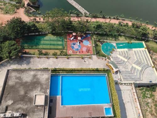 an overhead view of a swimming pool with a resort at Modern 3BHK with fully equipped kitchen on 15Floor only for families in Bengaluru