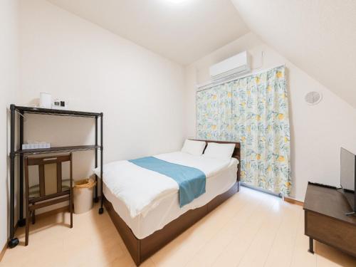 a small bedroom with a bed and a window at Shinjuku/Shin-Okubo Sta 2min walk/Kabukicho 5 min in Tokyo