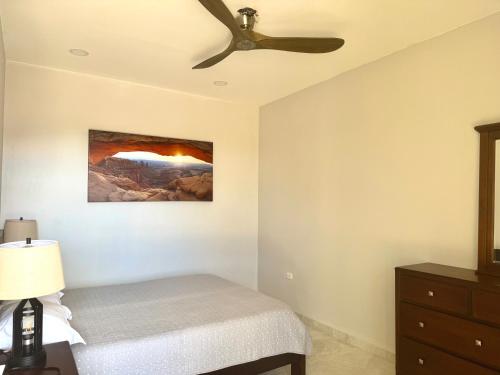 a bedroom with a bed and a ceiling fan at Villas with breathtaking seaview in Marbella