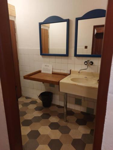 a bathroom with a sink and a mirror at Rekreační středisko ROJANA in Svratka