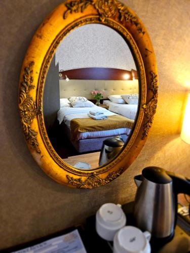 a mirror on the wall of a hotel room at Hotel Galicja SPA Wieliczka in Wieliczka