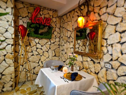 a table in a restaurant with a stone wall at Hotel Galicja SPA Wieliczka in Wieliczka