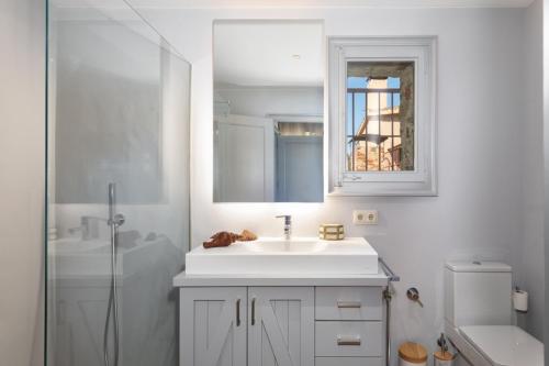 a white bathroom with a sink and a shower at Exquisite farmhouse in the Empordà Costa Brava in Vall-Llobrega