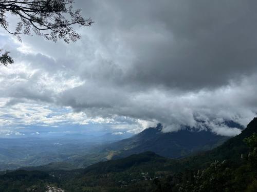 a view of a mountain under a cloudy sky at Sana's homestay haputhale in Haputale