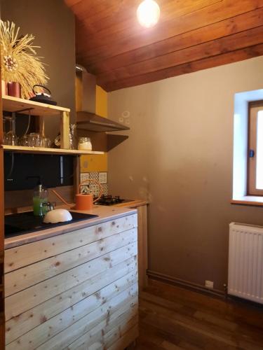 une cuisine avec un comptoir en bois dans une pièce dans l'établissement Au fil de l'Ance, à Beauzac