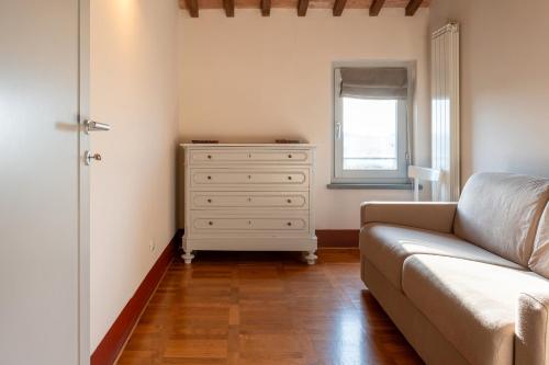 a living room with a couch and a dresser at Borgo Syrah in Cortona