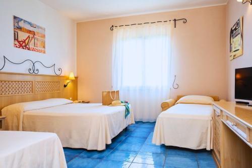 Postel nebo postele na pokoji v ubytování Hotel Ipomea Club
