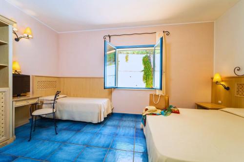 Postel nebo postele na pokoji v ubytování Hotel Ipomea Club