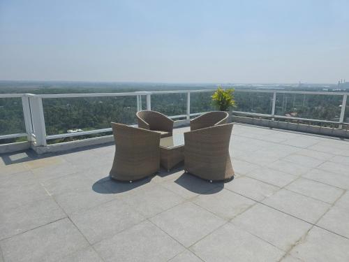 two chairs sitting on top of a balcony at Luxury Beachfront Apartment in Bopitiya