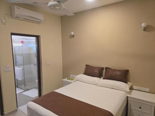 a bedroom with a bed and a walk in shower at Luxury Beachfront Apartment in Bopitiya