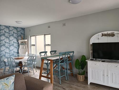 a living room with a couch and a table at Ocean Breaks in Umdloti