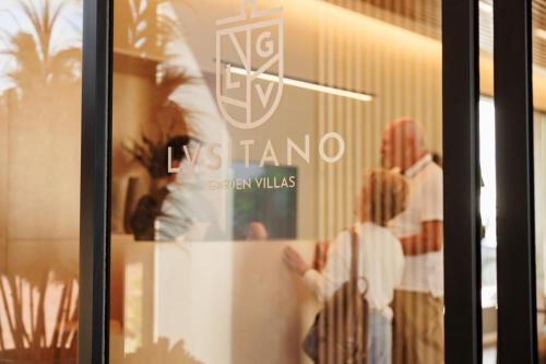 a window of a store with a sign on it at Lusitano Garden Villas in Ponta Delgada