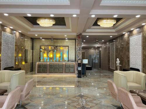 a lobby with chairs and a painting on the wall at Outstay Executive Apartments in Navi Mumbai