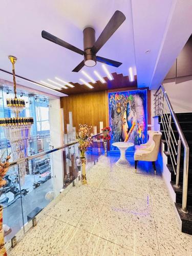 a living room with a ceiling fan and a painting at Hotel Mayfair Just a Minute Away From New Delhi Railway Station and Connaught place in New Delhi