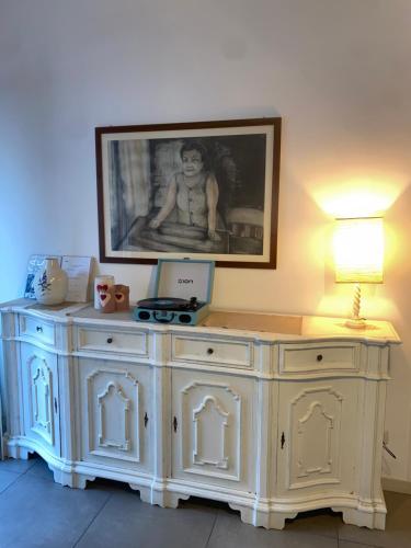 a large white cabinet with a picture on the wall at Casa Vacanze Nonna Elena in Rome