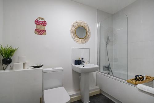 a white bathroom with a sink and a toilet and a tub at Affordable 1 & 2 Bed Apartments in Slough, Great Heathrow Location in Colnbrook