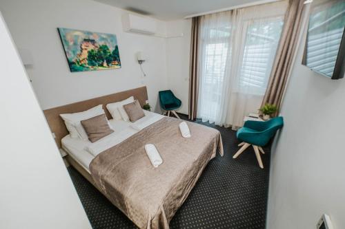 Postel nebo postele na pokoji v ubytování Arena Deluxe & Spa