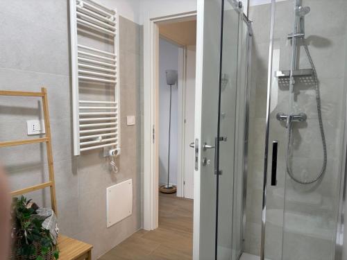 a bathroom with a shower with a glass shower stall at VINCI - Narramondo Villas in Tortoreto Lido