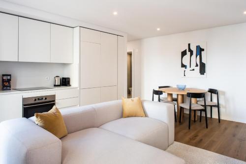 a living room with a white couch and a table at The Haus Santa Bárbara I Lisbon in Lisbon