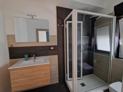 a bathroom with a sink and a shower at Cambria Rooms & Apartments in Catania
