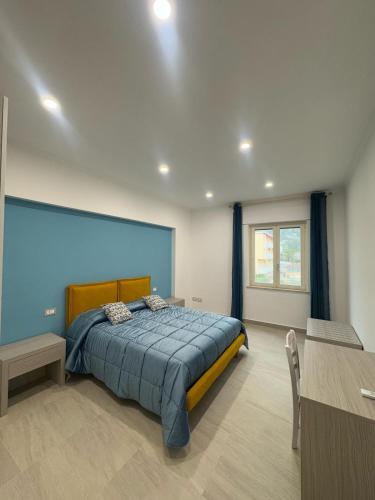 a bedroom with a large bed with a blue wall at Casa Franco in Sant'Agnello