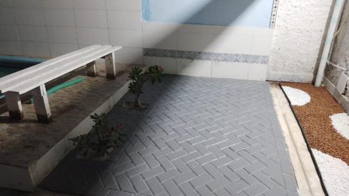 a bathroom with a bench next to a pool at CASA DE TEMPORADA RECANTO FELIz 2 in Aracaju