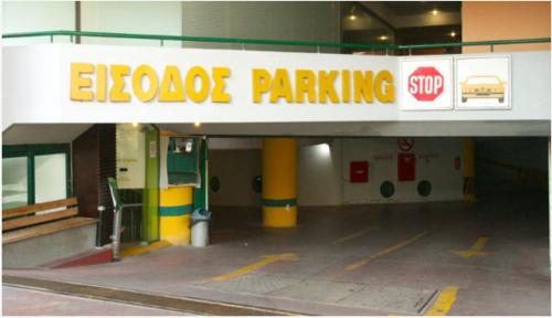 a parking garage with a stop sign on it at Sky 7 View Apartment in Heraklion