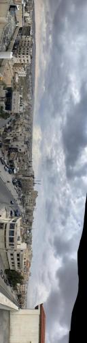 a cloudy sky with a row of buildings on a street at Osama Alnaser in Amman