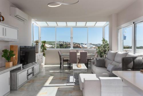 a living room with a couch and a table at Stunning Beachfront Penthouse in Estepona