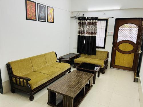 a living room with a couch and a coffee table at Gotawala Villa 11 in Daman