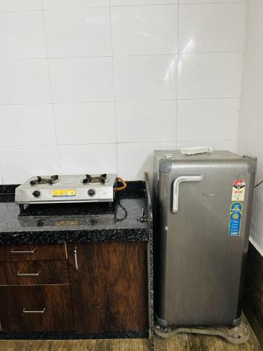 a kitchen with a stove and a refrigerator at Gotawala Villa 11 in Daman
