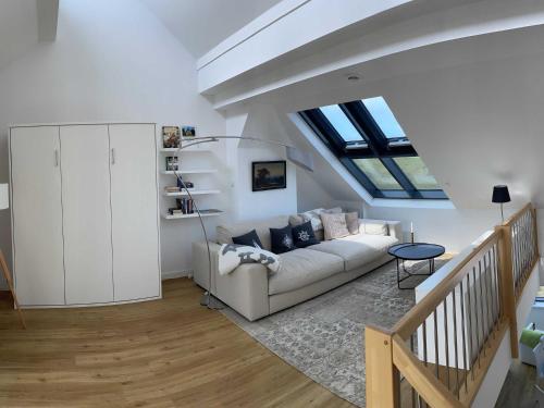 a living room with a couch and a skylight at Tor zum Meer in Helgoland