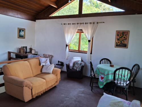 a living room with a couch and a table at Cantinho da Serra in Santo Antônio do Pinhal
