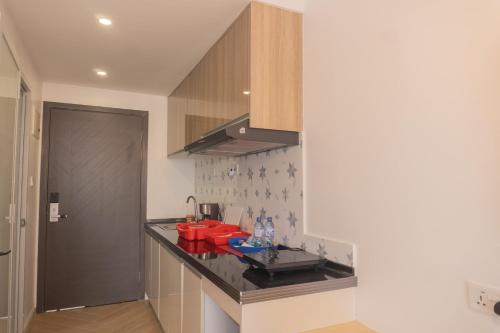 a kitchen with a black counter top in a room at Laurell Hill Suites, Upper Hill in Nairobi