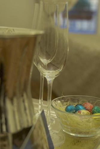 two wine glasses sitting next to a bowl of eggs at Locanda Navona in Rome